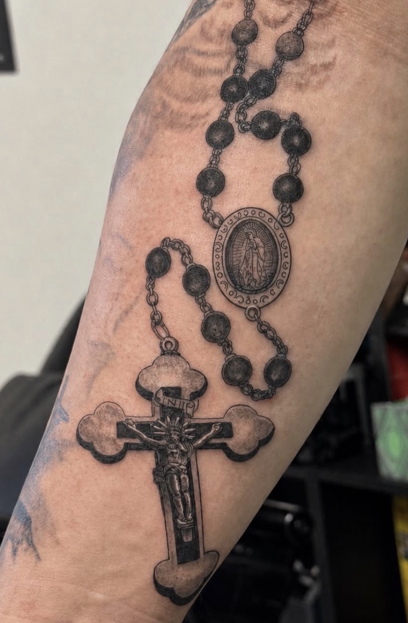 Rosary and crucifix tattoo by Jake Bebout at Snafu Tattoo Studio in Wilmington NC