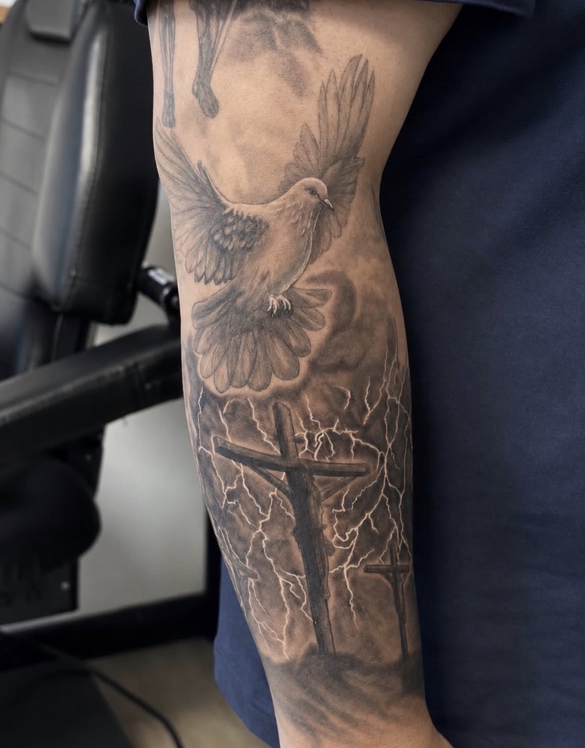 Black and grey realism dove and crosses tattoo by Jake Bebout at Snafu Tattoo Studio in Wilmington NC